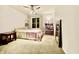 Cozy bedroom features a ceiling fan, carpet flooring, a window with curtains, and shelving for storage and decor at 12441 Bent Oak Ln, Indianapolis, IN 46236