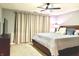 Bedroom with carpet, dark wood furnishings, a large bed with decorative pillows, and tan colored window coverings at 12441 Bent Oak Ln, Indianapolis, IN 46236