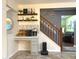 Charming coffee bar area with custom shelving and decor adjacent to the stairs at 12441 Bent Oak Ln, Indianapolis, IN 46236