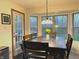Cozy dining area with a view from many windows, featuring a wood table set with chairs, and access to outdoor at 12441 Bent Oak Ln, Indianapolis, IN 46236