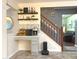 A welcoming entryway with tile flooring, decorative shelving, and views of the staircase and living area at 12441 Bent Oak Ln, Indianapolis, IN 46236
