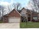 Charming two-story home with a brick facade, attached two car garage, and well-maintained landscaping at 12441 Bent Oak Ln, Indianapolis, IN 46236