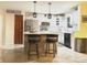 Bright eat-in kitchen features white cabinets, stainless steel appliances, an island with seating, and modern pendant lighting at 12441 Bent Oak Ln, Indianapolis, IN 46236