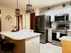 Well-lit kitchen featuring stainless steel appliances, an island with a white countertop, and updated cabinets at 12441 Bent Oak Ln, Indianapolis, IN 46236