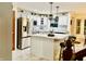 Bright kitchen features white cabinets, stainless steel appliances, island with bar seating, and stylish pendant lighting at 12441 Bent Oak Ln, Indianapolis, IN 46236