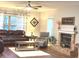Comfortable living room with a brick fireplace, plush furniture, and natural light from the window at 12441 Bent Oak Ln, Indianapolis, IN 46236