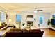 Living room with a charming fireplace, ceiling fan, and hardwood floors at 12441 Bent Oak Ln, Indianapolis, IN 46236
