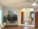 The living room boasts hardwood floors, a ceiling fan, with large windows and TV at 12441 Bent Oak Ln, Indianapolis, IN 46236