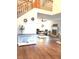 Open-concept living room leading to foyer, featuring modern decor and hard wood floors at 12441 Bent Oak Ln, Indianapolis, IN 46236
