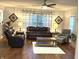 Cozy living room featuring a brown leather sofa, matching armchair, and a light gray armchair at 12441 Bent Oak Ln, Indianapolis, IN 46236