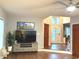 Bright living room featuring hard wood floors, a view of the front door and large TV and entertainment stand at 12441 Bent Oak Ln, Indianapolis, IN 46236