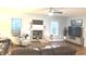 Comfortable living room with a brick fireplace, plush furniture, and natural light from the windows at 12441 Bent Oak Ln, Indianapolis, IN 46236