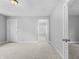 Bright living room featuring neutral-toned walls, plush carpeting, and ample natural light at 1313 W Memorial Dr, Muncie, IN 47302