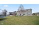 Fenced backyard featuring a grass yard, play set, trampoline, and durable siding at 1436 Amberwoods Ct, Indianapolis, IN 46239