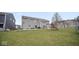 A spacious backyard with a grass yard, a play set, a basketball hoop, and a concrete patio at 1436 Amberwoods Ct, Indianapolis, IN 46239