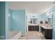 Well lit bathroom with double vanity, tub, and separate shower at 1436 Amberwoods Ct, Indianapolis, IN 46239