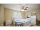 Bedroom with white furnishings, carpeted floors, ceiling fan, and a window for natural light at 1436 Amberwoods Ct, Indianapolis, IN 46239