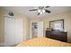 View of bedroom with large double door closet, dresser, and doorway leading to landing and stairs at 1436 Amberwoods Ct, Indianapolis, IN 46239