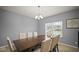 Traditional dining room with seating for six beneath a chandelier at 1436 Amberwoods Ct, Indianapolis, IN 46239