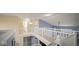 Upstairs hallway showcasing white railings, neutral walls, and a view of the staircase below at 1436 Amberwoods Ct, Indianapolis, IN 46239