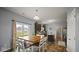 Dining area adjacent to a kitchen with stainless steel appliances and dark cabinetry at 1436 Amberwoods Ct, Indianapolis, IN 46239