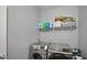 Functional laundry room with modern washer and dryer, plus ample shelving for storage at 1436 Amberwoods Ct, Indianapolis, IN 46239