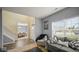 Inviting living room with gray sofa, a cozy chair, and large windows offering neighborhood views at 1436 Amberwoods Ct, Indianapolis, IN 46239