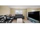 Comfortable living area with black leather seating, a large TV, and bright natural light at 1436 Amberwoods Ct, Indianapolis, IN 46239