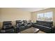 Home theater room with black leather recliners, large TV, and a window for natural lighting at 1436 Amberwoods Ct, Indianapolis, IN 46239