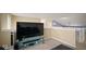 Cozy loft area featuring a large television and neutral colored walls at 1436 Amberwoods Ct, Indianapolis, IN 46239