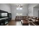 Bright living room featuring hardwood floors, a ceiling fan, and ample natural light at 1436 Amberwoods Ct, Indianapolis, IN 46239