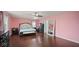Spacious primary bedroom with hardwood floors and stylish furnishings at 1436 Amberwoods Ct, Indianapolis, IN 46239