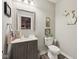 Cozy half-bathroom featuring modern fixtures, decor, and stylish Michigan-shaped wall decoration at 1442 Avondale Dr, Westfield, IN 46074