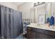 Functional bathroom with vanity, shower curtain, shelves, and well-placed lighting, offering a clean and efficient space at 1442 Avondale Dr, Westfield, IN 46074