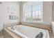 A luxurious bathtub area features a soaking tub, decorative starfish accents, and natural light from a window at 1442 Avondale Dr, Westfield, IN 46074