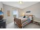 Inviting bedroom featuring a cozy bed, neutral walls, and a bright window with view of the outdoors at 1442 Avondale Dr, Westfield, IN 46074