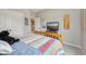 A bedroom featuring a bed with colorful patchwork quilt, neutral paint and artistic decor at 1442 Avondale Dr, Westfield, IN 46074