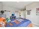 Comfortable bedroom features baseball decor, a small tv, and decor shelves on the wall, complemented by neutral walls at 1442 Avondale Dr, Westfield, IN 46074