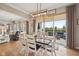 Open dining room with wood table and white chairs, leading to a cozy living room and outdoor patio at 1442 Avondale Dr, Westfield, IN 46074
