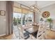 Bright dining room featuring a wooden table, white chairs, and sliding glass doors to the outdoor patio at 1442 Avondale Dr, Westfield, IN 46074