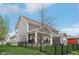 Exterior rear view of a two-story home featuring a fenced yard, patio, and deck at 1442 Avondale Dr, Westfield, IN 46074