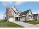 Attractive gray home featuring an attached garage, driveway, manicured lawn and an American flag at 1442 Avondale Dr, Westfield, IN 46074