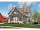 Side view of a gray two-story home with manicured lawn and neutral colored roof at 1442 Avondale Dr, Westfield, IN 46074