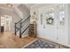 Welcoming foyer featuring a staircase, stylish decor, hardwood floors, and a glass-paneled front door at 1442 Avondale Dr, Westfield, IN 46074