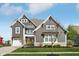 Charming two-story home with a yellow front door, attached garage, and well-maintained lawn at 1442 Avondale Dr, Westfield, IN 46074