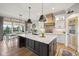 Open kitchen featuring a large island, stainless steel appliances, custom range hood, and adjacent dining area at 1442 Avondale Dr, Westfield, IN 46074