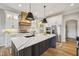 Bright and modern kitchen featuring white cabinets, a center island with a black sink, and stainless steel appliances at 1442 Avondale Dr, Westfield, IN 46074