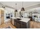 Spacious kitchen island with dark cabinetry, white countertops, and stylish pendant lighting at 1442 Avondale Dr, Westfield, IN 46074