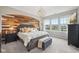 Stylish main bedroom with a wood accent wall, a large bed, and three windows, offering serene views at 1442 Avondale Dr, Westfield, IN 46074