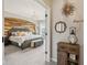 An inviting main bedroom with a wooden accent wall and modern chandelier, flowing seamlessly into the hall at 1442 Avondale Dr, Westfield, IN 46074